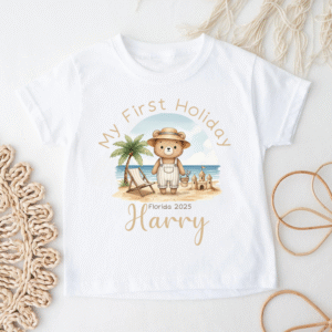 White baby t-shirt with teddy bear in holiday beach scene and palm tree