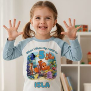Child wearing personalised under the sea birthday pyjamas on birthday morning