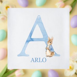 personalised easter bunny initial children’s t-shirt flat lay with pastel easter eggs