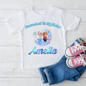 Personalised promoted to big sister t-shirt with frozen inspired design and custom name on white kids shirt flat lay