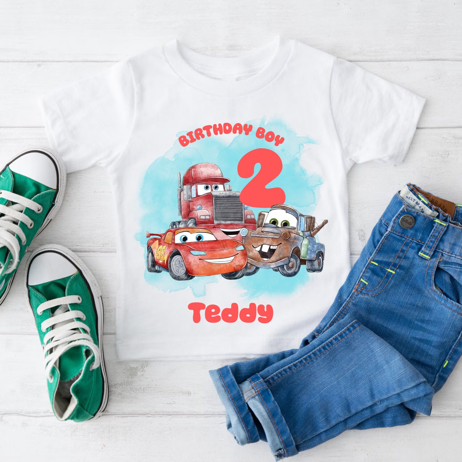 Cars themed personalised birthday t-shirt flat lay with denim shorts and trainers