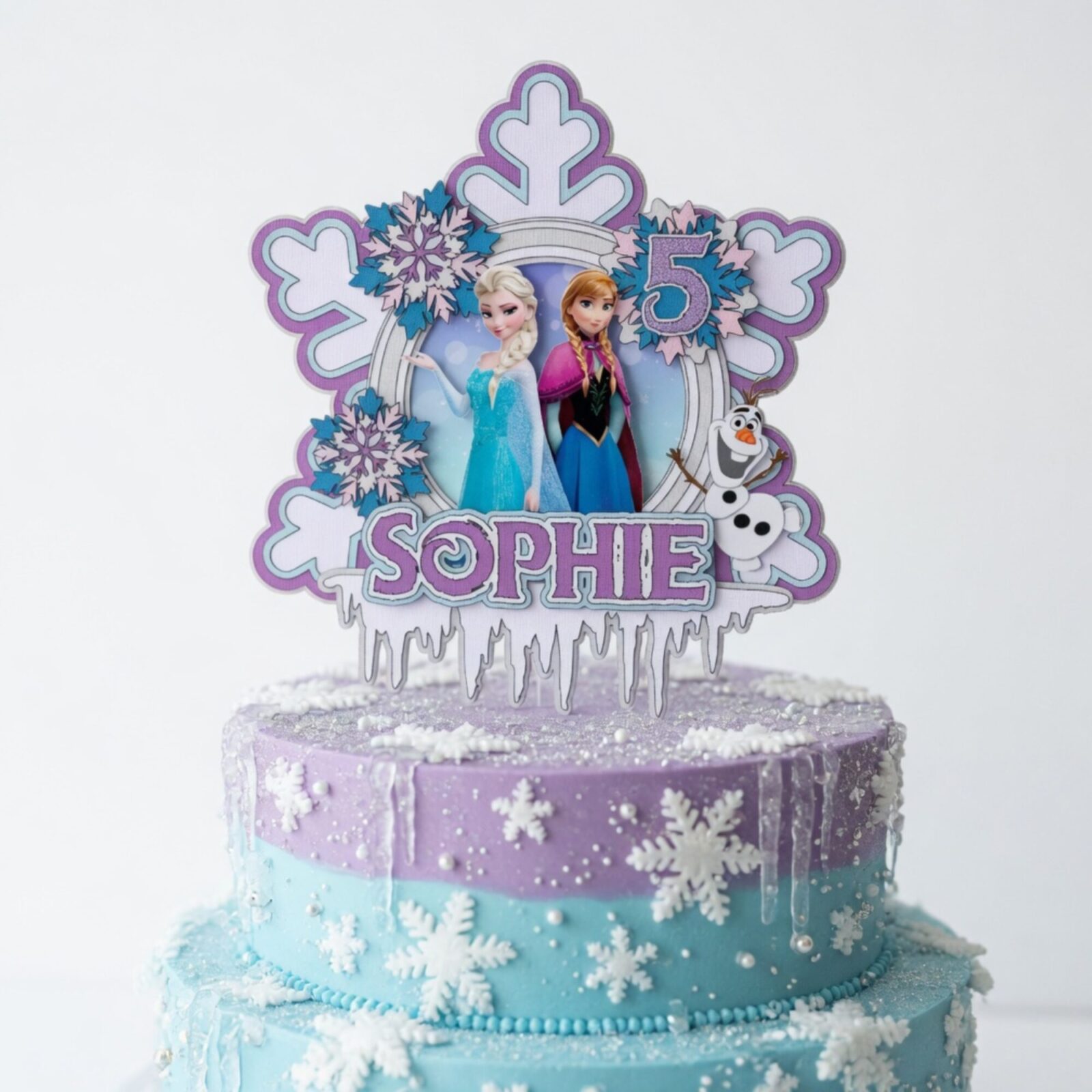 Personalised Frozen cake topper with custom name Sophie and age 5 displayed on winter wonderland birthday cake