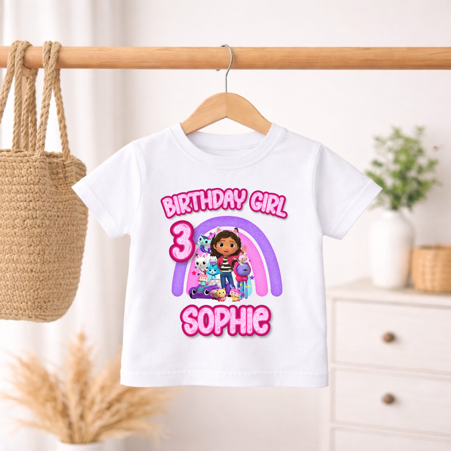 Personalised Gabby's Dollhouse birthday outfit featuring custom age and name hanging on clothing rail