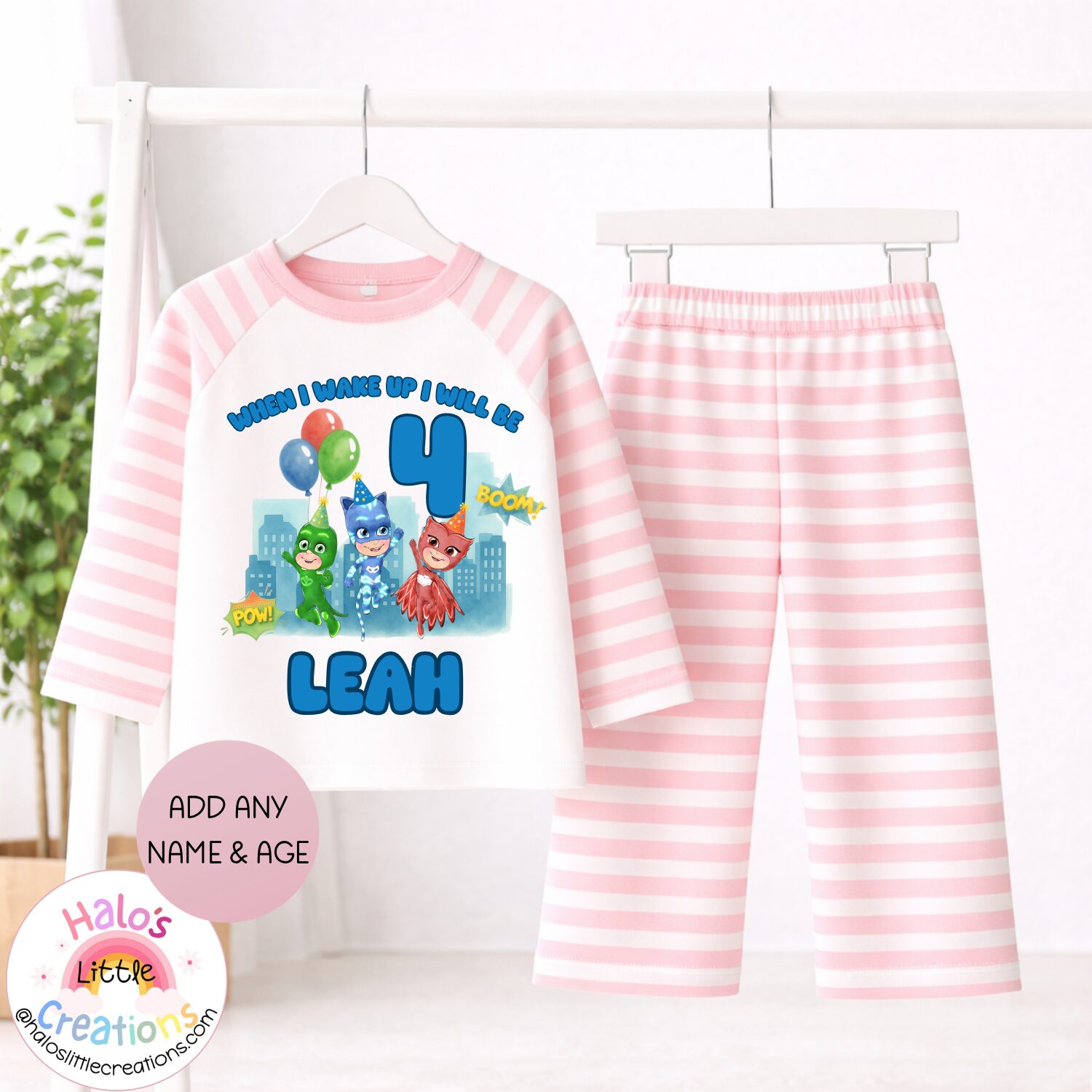 Child wearing personalised PJ Masks birthday pyjamas with custom name and age in bedroom