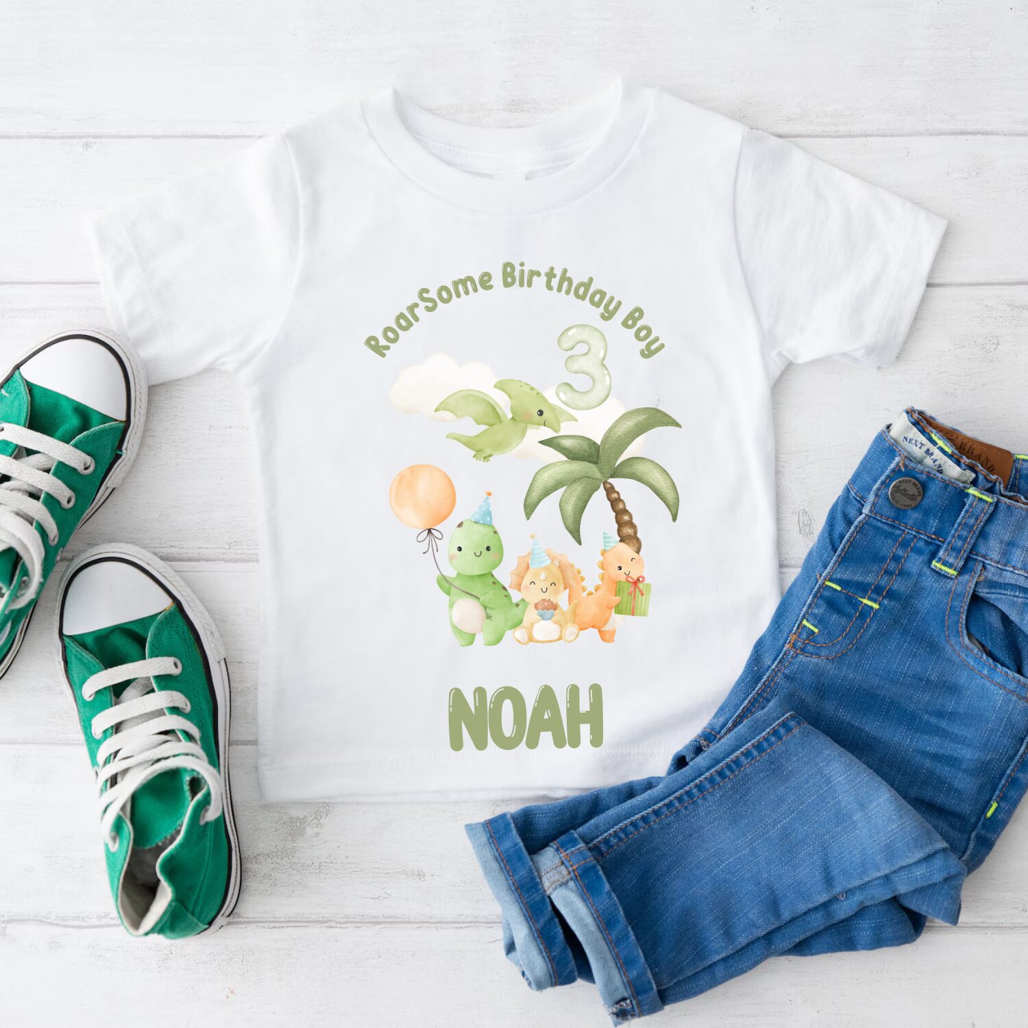 Folded personalised birthday boy dinosaur t-shirt with custom name Noah