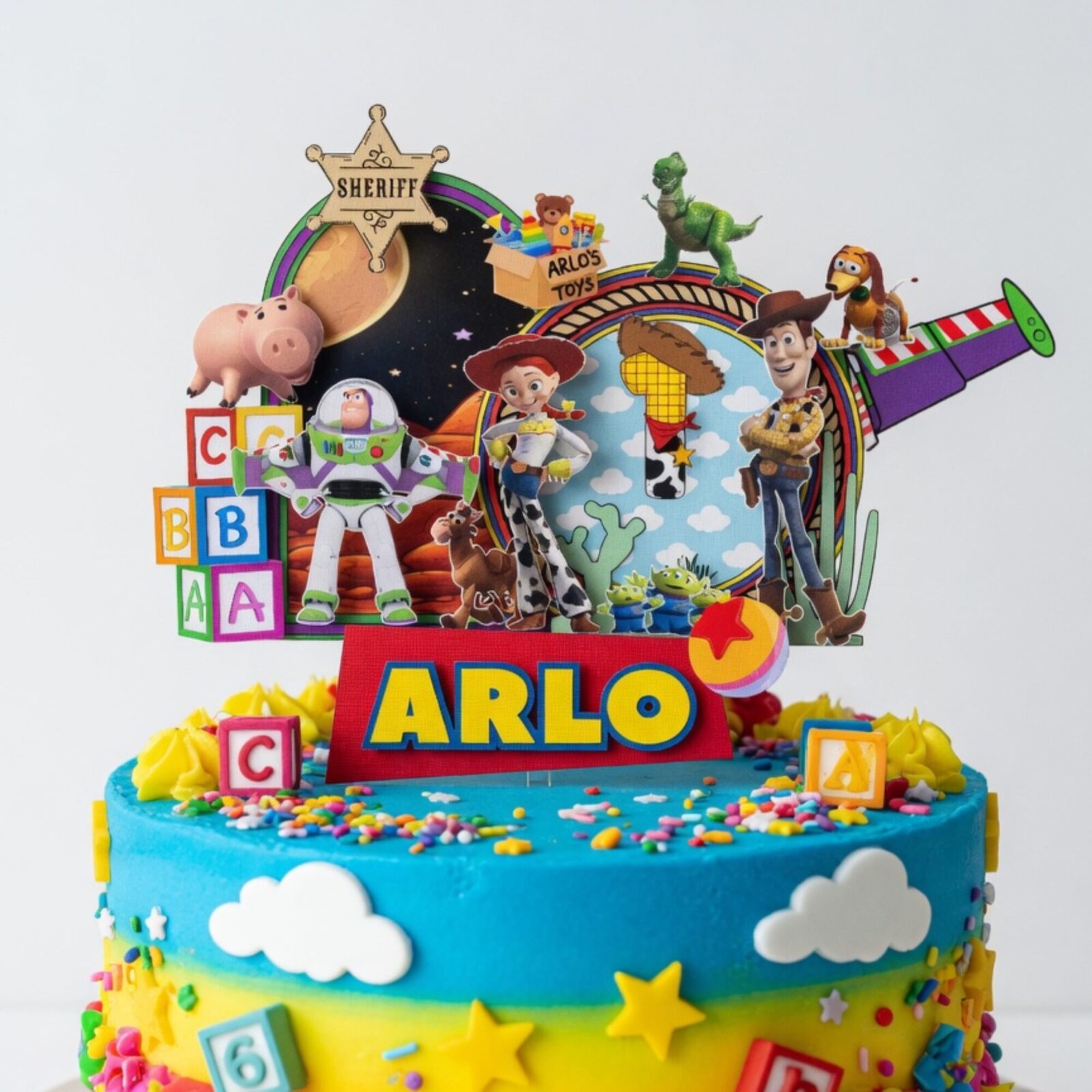personalised toy story cake topper – custom name & age birthday cake decoration Personalised Toy Story birthday cake topper displayed on blue birthday cake with custom name and age decoration