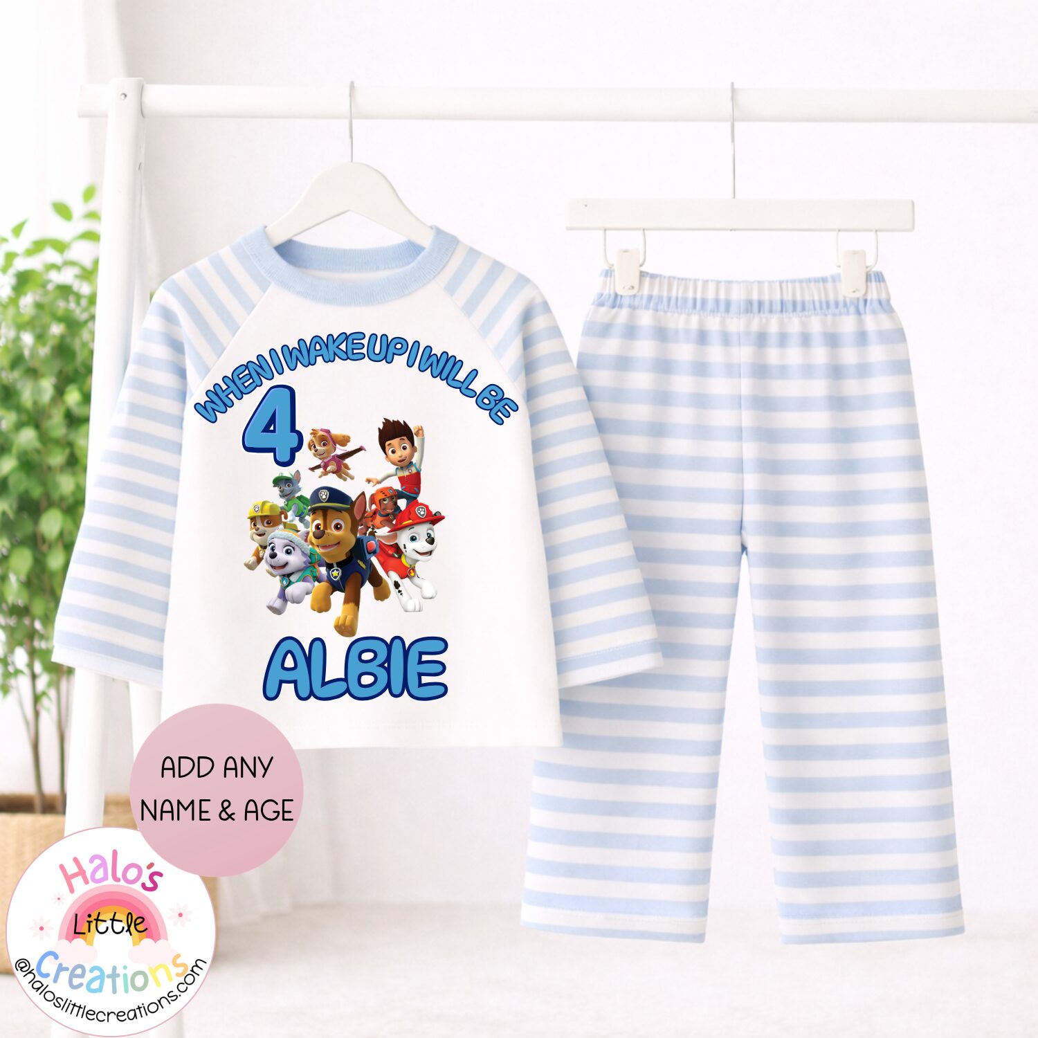Personalised blue striped Paw Patrol children's birthday pyjamas with custom name and age printed on the top.