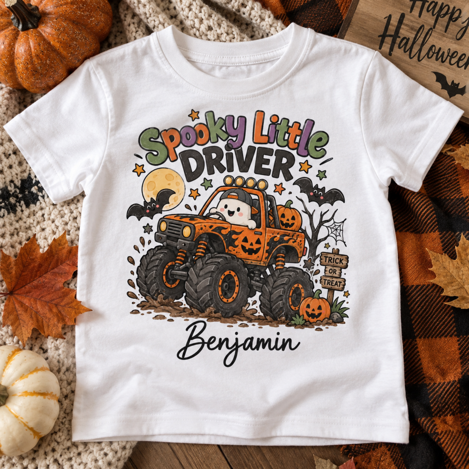 personalised halloween tshirt spooky little driver flatlay Child wearing personalised Spooky Little Driver Halloween T-shirt with monster truck design