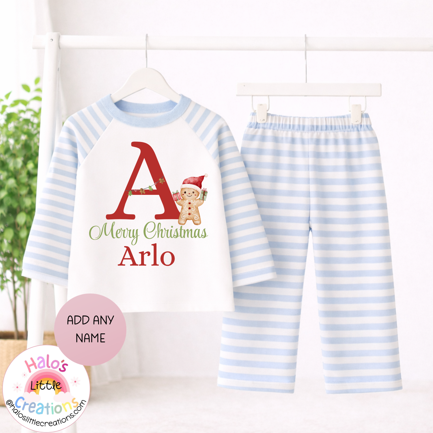 Personalised boys Christmas pyjamas with baby blue and white striped sleeves and trousers, red festive initial, gingerbread man and name Arlo.